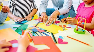 A group of children sitting around a table making crafts