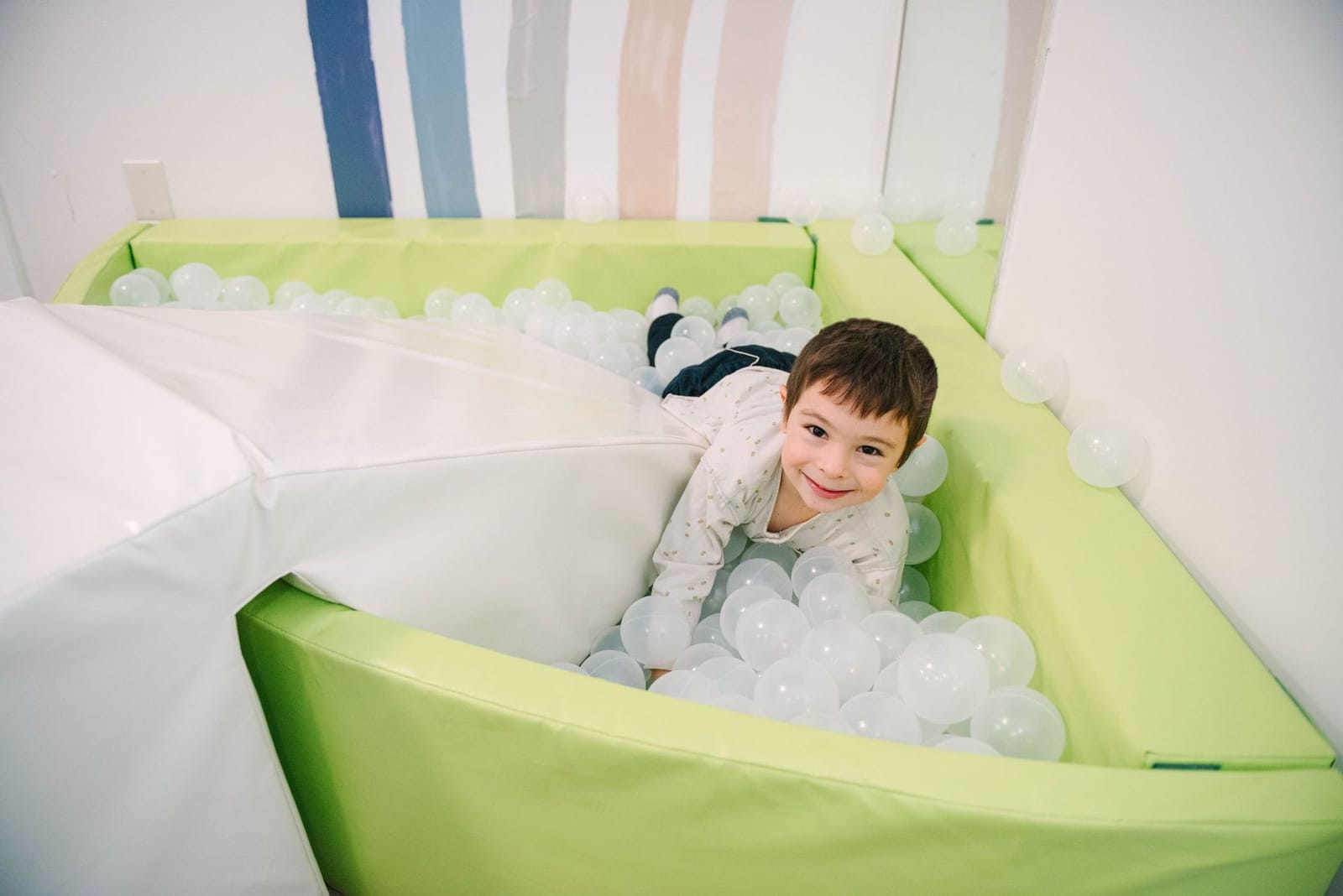 Sensory play area with climbing wall, swings, and soft play equipment at the Steady Strides Houston ABA center.