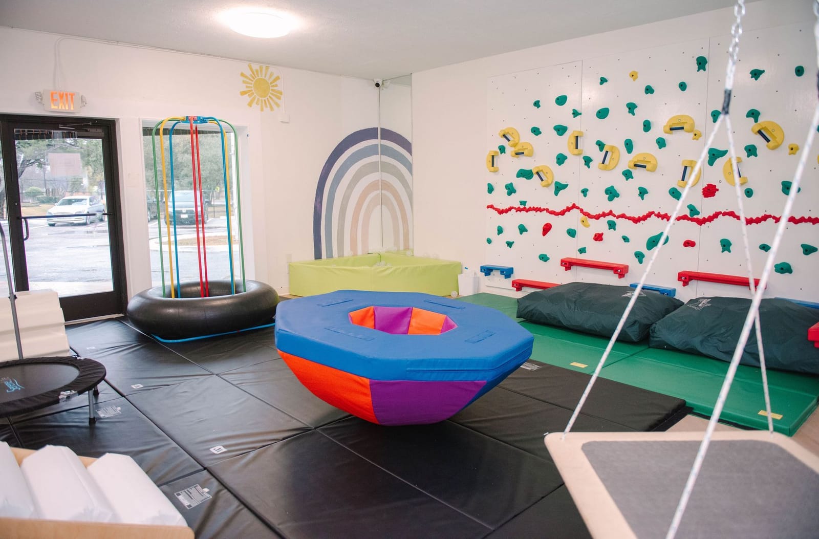 Children's play space with soft mats and sensory equipment at the Steady Strides Houston ABA center.